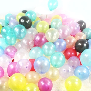 Colorful pearl latex balloons for party decoration on a white fluffy carpet