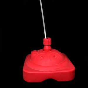 Detail of red water-filled weight base for balloon arch and foldable banner stands