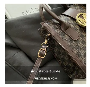Detailed close-up of the adjustable gold-tone metal buckle on the leather strap