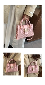 Detail of pink monogram tote bag featuring a gold M hardware and leather shoulder strap