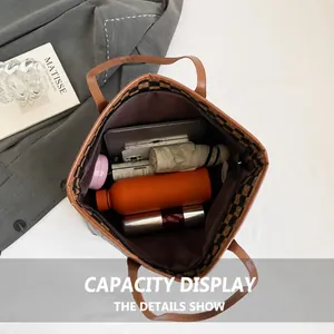 Spacious interior of brown tote bag showing capacity for laptop and daily essentials