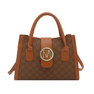 Brown monogram tote bag with gold M-logo buckle and top handles on white background