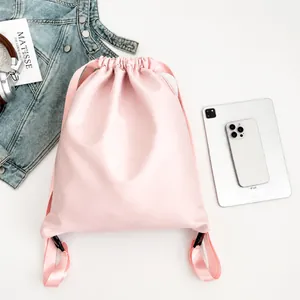 Detailed top view of pink drawstring backpack with daily essentials and leather texture