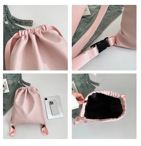 Pink waterproof nylon drawstring backpack detail showing inner lining and strap buckles
