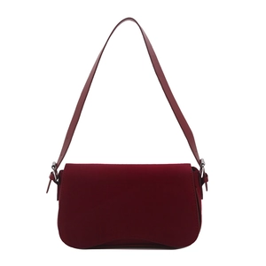 Minimalist burgundy suede baguette shoulder bag with silver hardware on white background