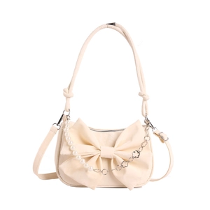 Chic cream bow shoulder bag with pearl and floral silver chain detail in 45-degree view