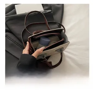 Macro view of woven straw tote bag interior with zipper pocket and brown leather trim
