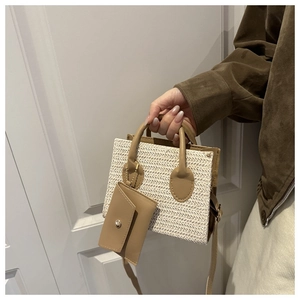 Detail of woven straw and leather small square bag with a matching coin purse attachment