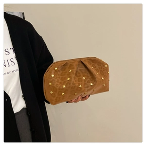 Detail showing brown leopard print clutch with gold studs and ruched texture