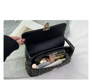 Detail view of the spacious interior of the plaid tweed handbag with essential items
