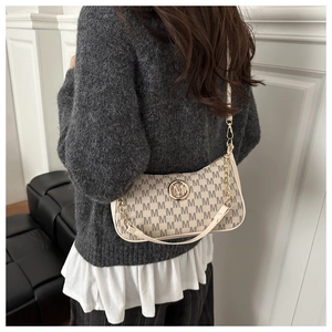 Detailed back view of vintage monogrammed crossbody bag with gold chain and M logo