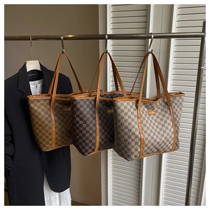 Detailed close-up of large capacity tote bags with classic checkered print and leather straps