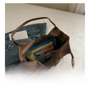 Interior view of large brown hobo bag showing spacious storage for tablet and umbrella
