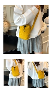 Detail of ginger nylon mini crossbody bag with drawstring closure and fashion label