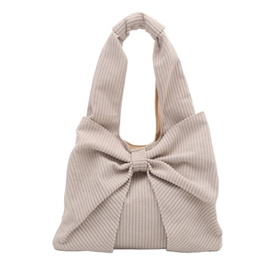Beige corduroy shoulder bag with large bow decoration for a vintage sweet fashion style