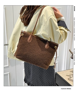 Detail of plush brown teddy fleece tote bag with premium leather handles and drawstrings