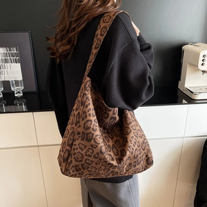 Vintage leopard print tote bag with large capacity and wide strap shown on a model