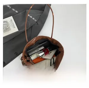 Top view of spacious brown faux leather tote bag showing capacity for daily essentials