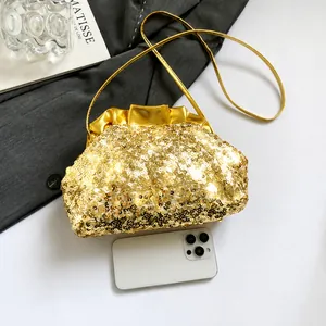 Detail of gold sequin cloud bag on grey blazer with phone for size reference