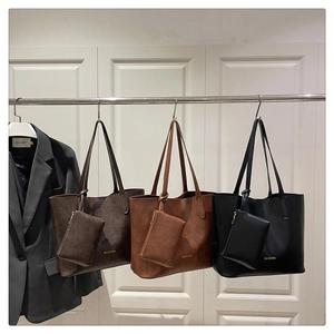 Detailed view of large capacity tote bags in coffee, brown and black with mini pouches