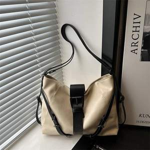 Minimalist large-capacity cream tote bag with black contrast straps and buckle detail