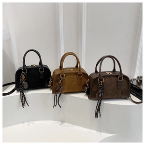Versatile crossbody Boston bags in black, yellow, and brown with tennis racket charms