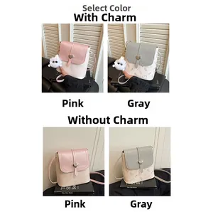 Comparison of pink and grey mini crossbody bags with heart clasp and optional fur pendant