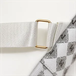 Detail of golden metal connector and logo pattern on white minimalist backpack strap