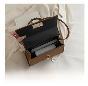 Interior view showing the storage capacity of a brown leather crossbody bag with items