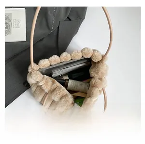 Top view of beige faux fur tote bag showing spacious interior with laptop and cosmetics