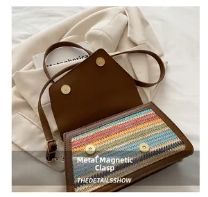 Detail of magnetic closure on brown leather straw bag with woven colorful panel