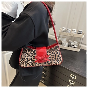 Chic leopard print shoulder bag with red patent leather bow and handle detail