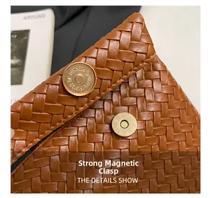 Detail of a brown woven PU leather handbag showing its dual strong magnetic gold clasps