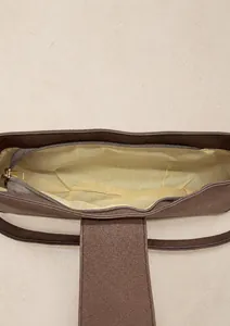 Detailansicht des Innenraums mit Textilfutter und goldenem Reißverschluss einer PU Tasche