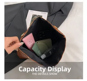 Top view showing large capacity of woven handbag with phone, wallet and cosmetics