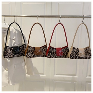 Detail view of stylish leopard print shoulder bags featuring retro bow buckles in four colors