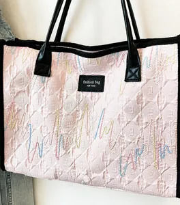 Detail of light pink tote bag with bubble texture and colorful wave embroidery