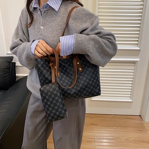 Sac cabas bleu à motif géométrique avec lanières en cuir marron porté par un mannequin