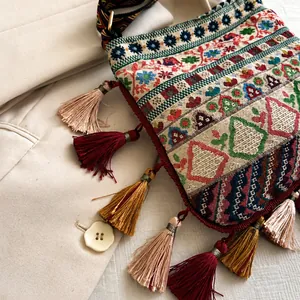 Detail of bohemian jacquard bag with ethnic tassel fringe and colorful embroidery