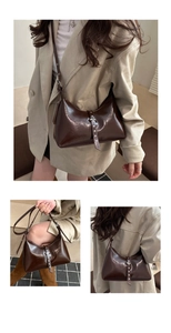 Detail of dark brown glossy croissant bag with silver buckle and rivet accents
