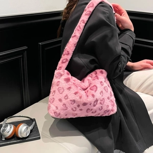 Chic pink leopard print faux fur shoulder bag for women styled in a modern setting