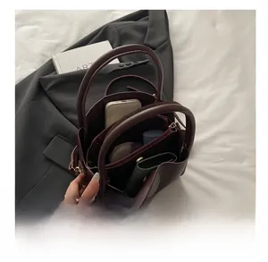 Interior view of leather bucket bag showing large capacity for phone and wallet
