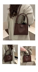 Detail of dark brown leather tote bag showing magnetic flap and dual strap versatility