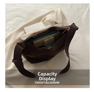 Brown large-capacity tote bag with wide strap showing interior space for books