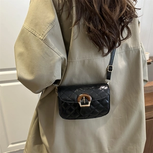 Classic black quilted crossbody bag with retro circular buckle and leather shoulder strap