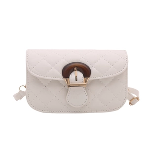White quilted crossbody bag with unique wooden buckle and gold lock on white background