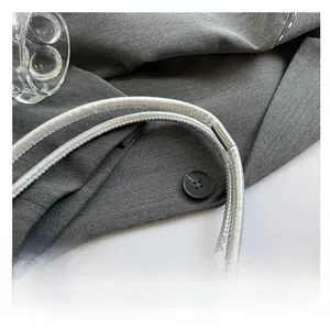 Detail shot of the silver leather shoulder strap showing fine texture and stitching