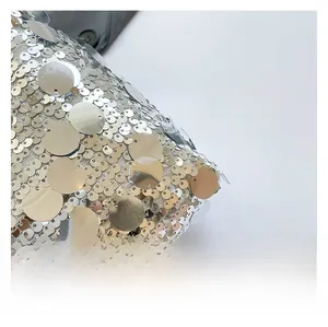 Detailed macro shot of silver and gold sequins on a stylish shoulder bag fabric