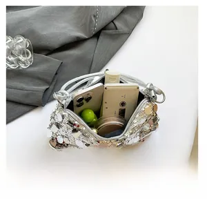 Top view of silver sequin handbag showing spacious interior for phone and cosmetics