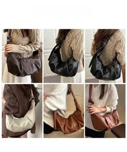 Detail of ruched leather crescent bags in various colors with stylish knotted strap detail